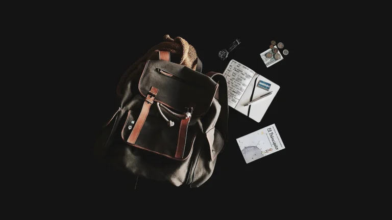 Travel essentials laid out in a flat lay, showing carry-on packing tips for traveling light