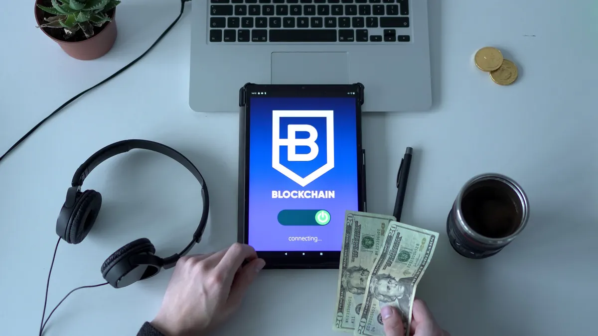 Crypto wallet app open on a tablet next to cash, illustrating crypto wallet security habits