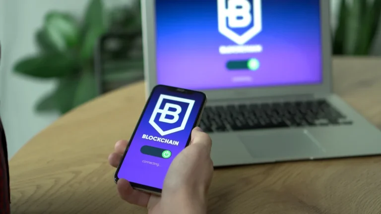 Crypto wallet security: smartphone running a blockchain wallet app beside a laptop