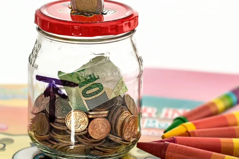 Emergency fund savings jar filled with coins and banknotes